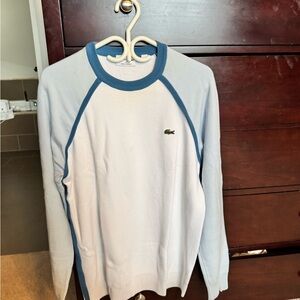 White and baby blue large men's Lacoste sweater.